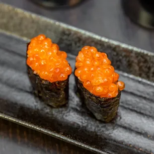 two pieces of sushi on a plate