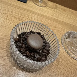 a bowl of coffee beans and a rock
