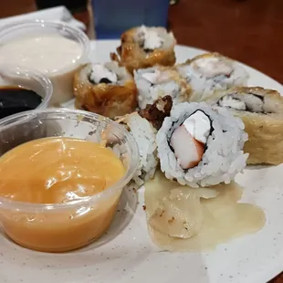 a plate of sushi and sauce