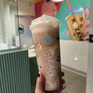 Ice cream black tea float with boba, light ice, and 50% sweetness