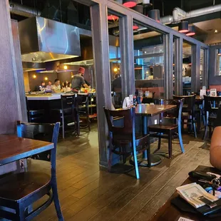 the interior of a restaurant with tables and chairs