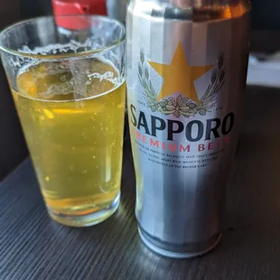 a can of sapporo and a glass of beer