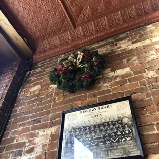 a wreath on a brick wall