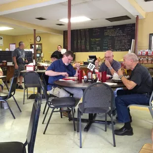 a group of people eating at a restaurant