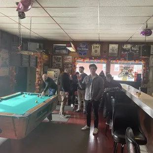 a pool table in the middle of the room