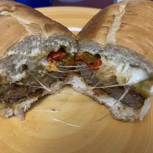 a sandwich cut in half on a yellow plate