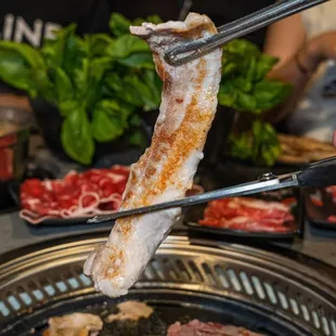 the meat being cooked on the grill