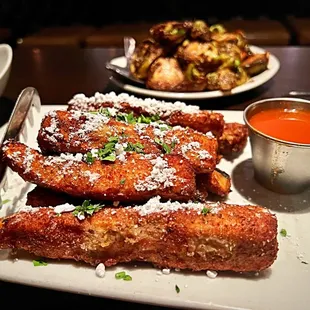 Eggplant Fries are a surprise with the powdered sugar and hot sauce. Intriguing.