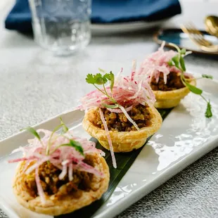 Chicken curry tart - sautéed minced chicken with curry powder, caramelized onion, sweet radish on top of crispy tart