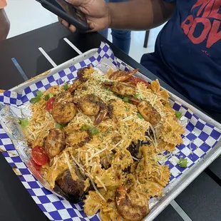 Turkey covered in shrimp with Cajun pasta.