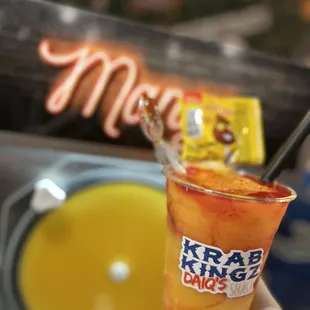 a hand holding a drink