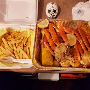Side of fries and a huge #1 tray filled with snow crab, potatoes, eggs, corn, sausage and all drenched in your choice of flavor!