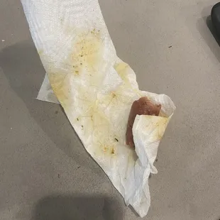 Sausage wrapped in paper towel.