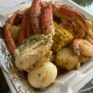 crab legs, potatoes and corn