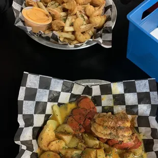 Fried shrimp and fries with bayou sauce and cocktail sauce. Lobster tail and potatoes with regular garlic butter. Yummy!