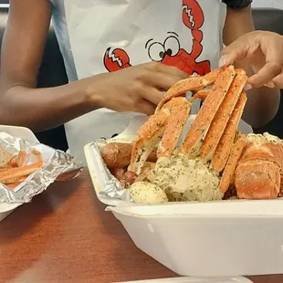 a girl holding a crab legs