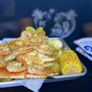 a tray of shrimp and corn