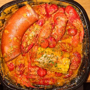 Crawfish swimming in water and butter. This dish is filled with water. It's not appealing at all.