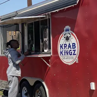 a man standing in front of a food truck