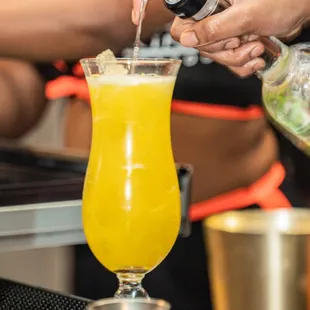 a bartender pouring a drink