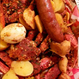Cluster, lobster, shrimp, potatoes, corn, and sausage.