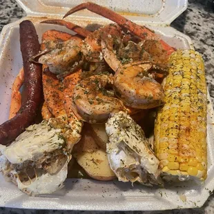 Combo plate with shrimp, crab legs, potatoes, corn and sausage in a butter garlic sauce!!