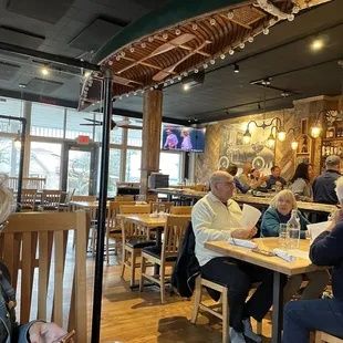people sitting at tables in a restaurant