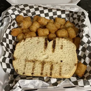 a sandwich and tater tots