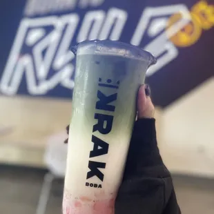 Matcha milk tea with pink crystal boba. Just as yummy as it looks