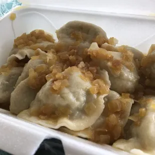 a close up of a dumpling in a styrofoam container