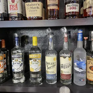 a shelf full of liquor bottles