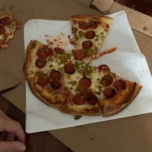a half eaten pepperoni pizza