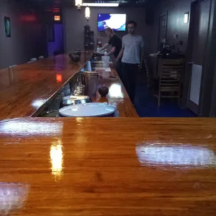 a man standing at the bar in a restaurant