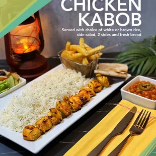 chicken kabob served with rice, salad, and fresh bread