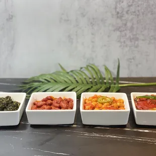 four bowls of different types of food