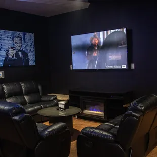 a television and leather recliners