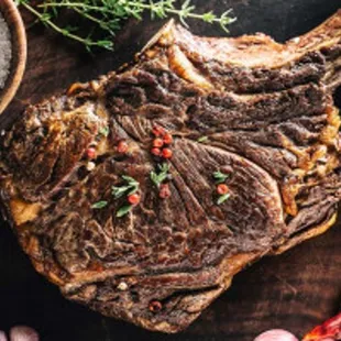 a steak on a cutting board with spices and salt