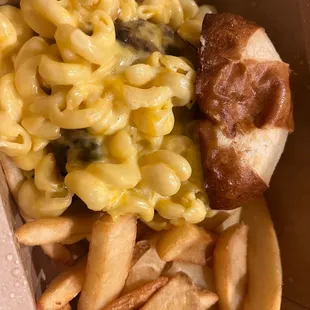 Mac and cheese stuffed burger with steak fries and a pretzel bun