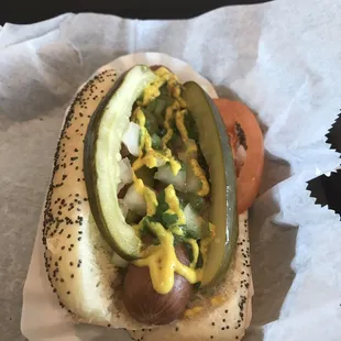 a hot dog with pickles and mustard