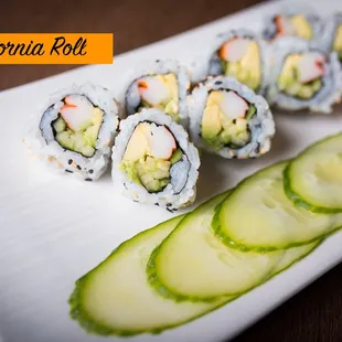 a plate of sushi rolls and cucumbers