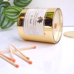 "VIVIAN" 8oz candle handpoured in a lustrous gold glass vessel, paired with artisan safety matches - a design to compliment any space!