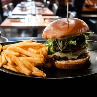 Krawbar Cheeseburger with angus beef, pickled cucumber, red onion, tomato, Arugula mixed greens, white cheddar cheese, ss sauce