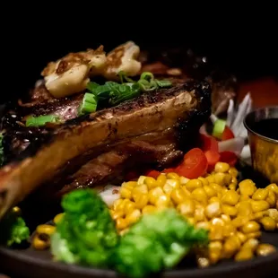 32oz. USDA Prime Tomahawk Steak with
corn, onions, seasonal veggies, miso butter, and fried shallots with seasoned rice