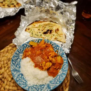 Chicken vindaloo and garlic naan bread.