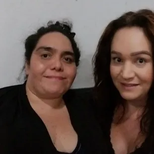 two women sitting on a couch