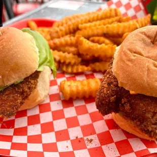 two fried chicken sandwiches and french fries