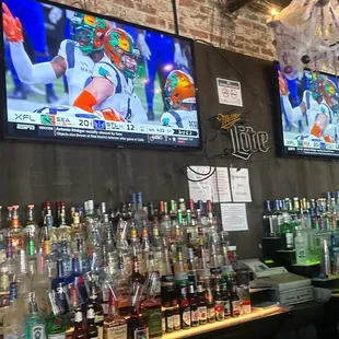 a bar with several televisions