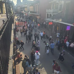 a crowd of people walking down a street