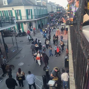 a crowd of people walking down a street