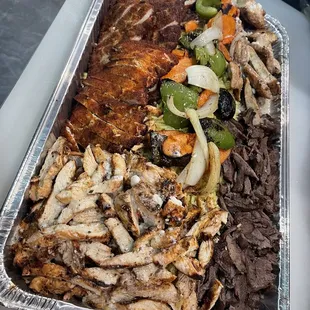 a tray of meat and vegetables